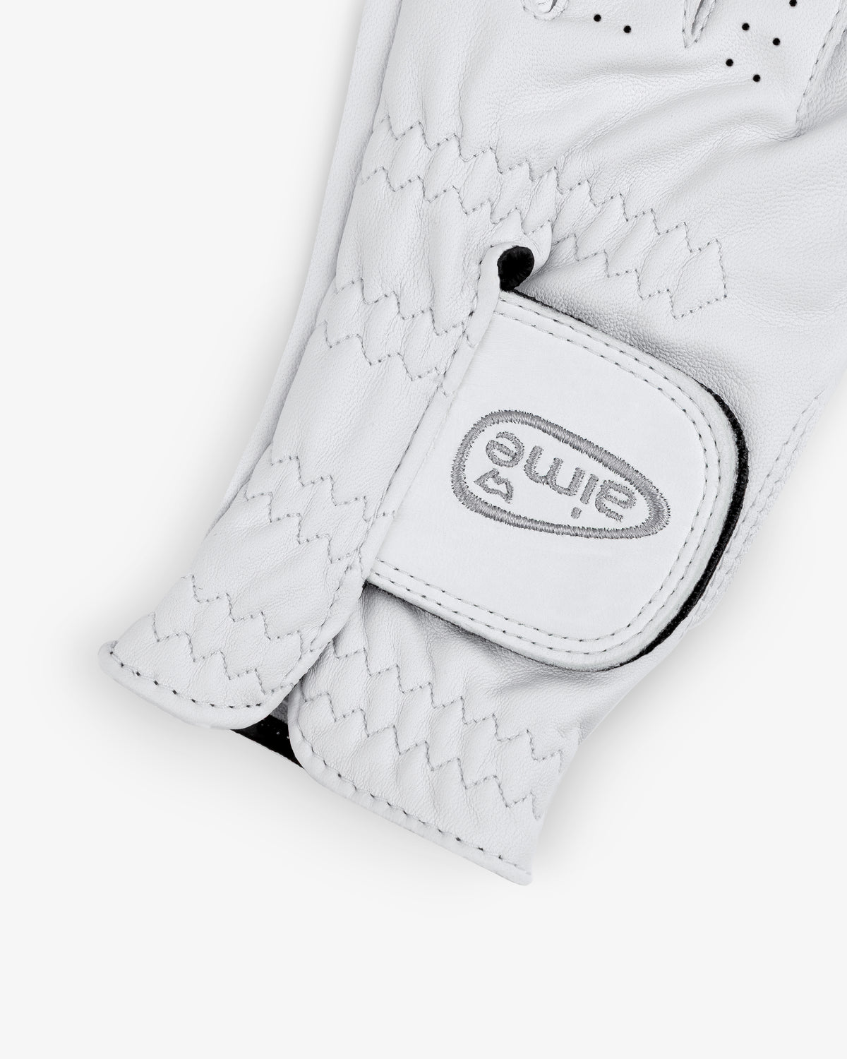 A close-up of the ALD / FootJoy StaSof Heritage Glove (Left) with "elime" and a heart logo on the Velcro strap.