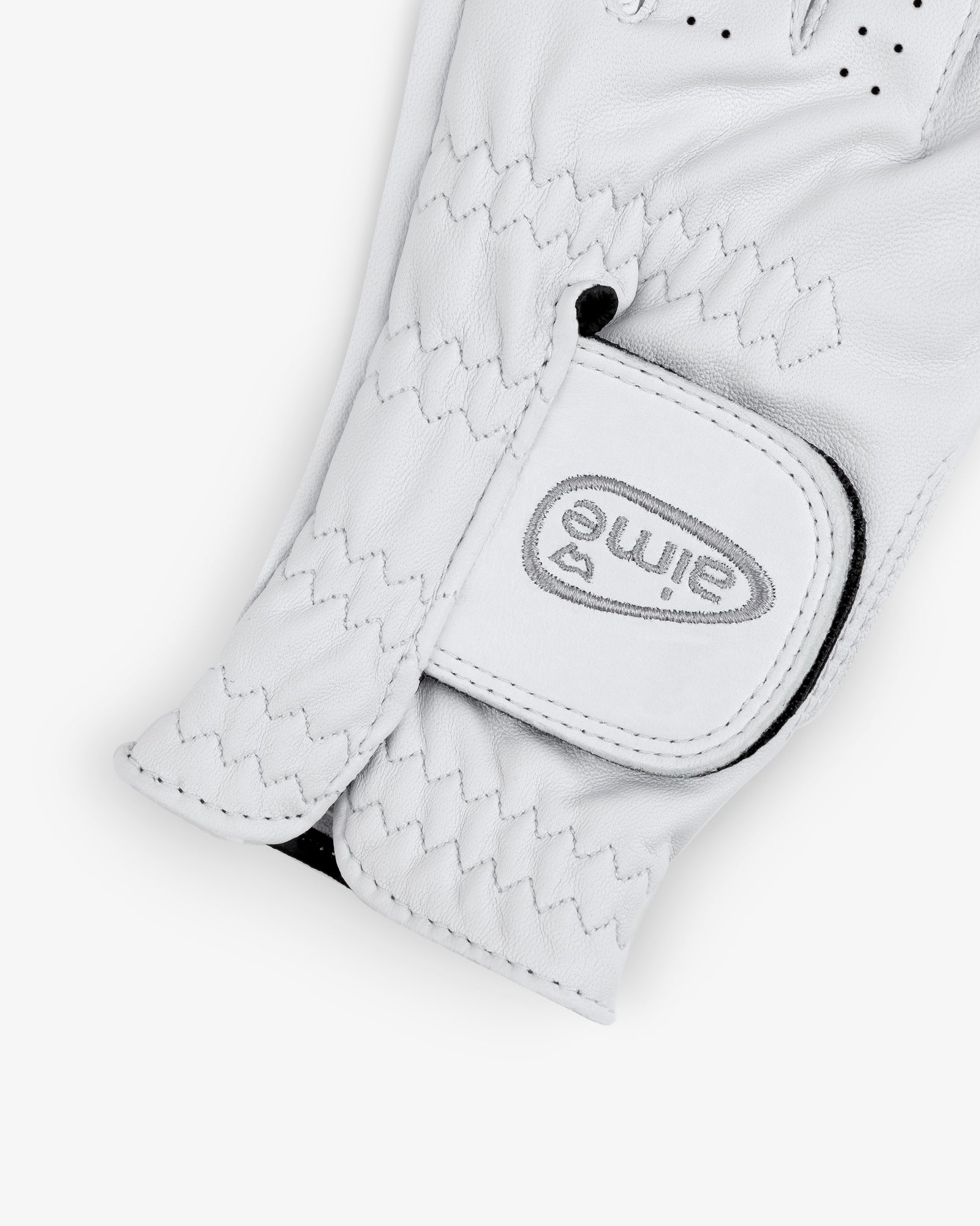 A close-up of the ALD / FootJoy StaSof Heritage Glove (Left) with "elime" and a heart logo on the Velcro strap.