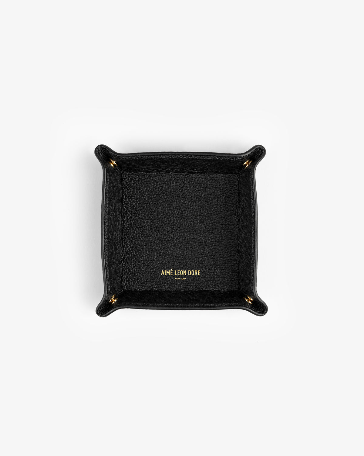 Black Leather Catchall with gold AIMÉ LEON DORE text in the center, shown from above on a white background.