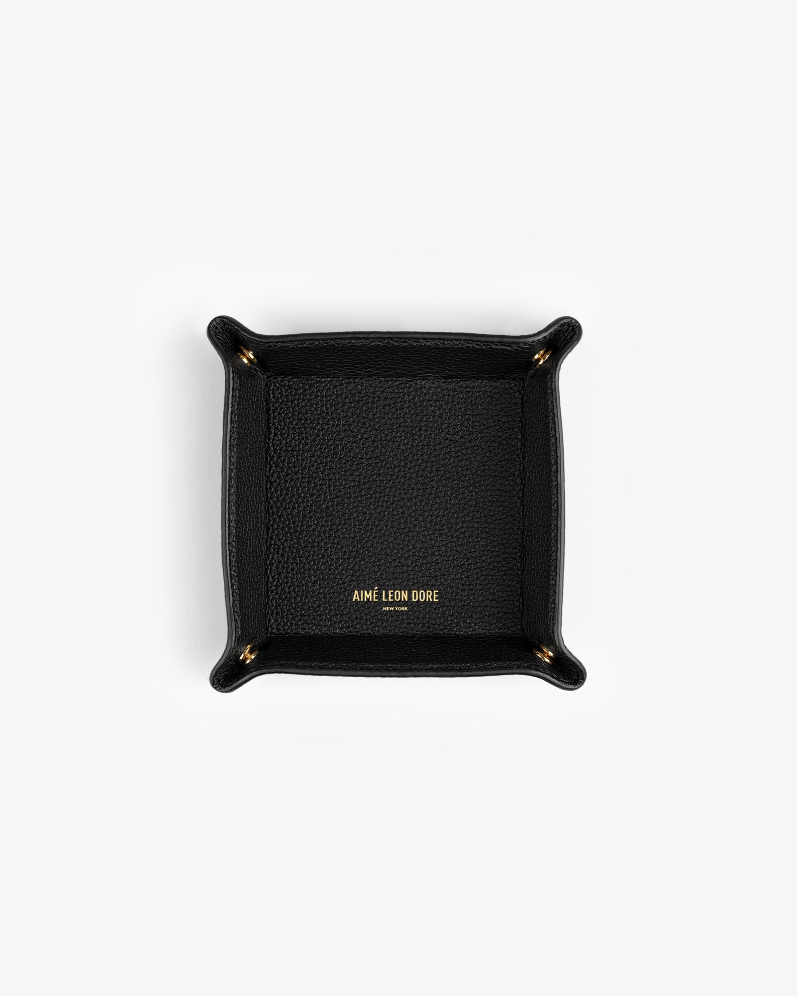 Black Leather Catchall with gold AIMÉ LEON DORE text in the center, shown from above on a white background.