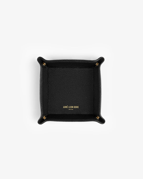 Black Leather Catchall with gold AIMÉ LEON DORE text in the center, shown from above on a white background.
