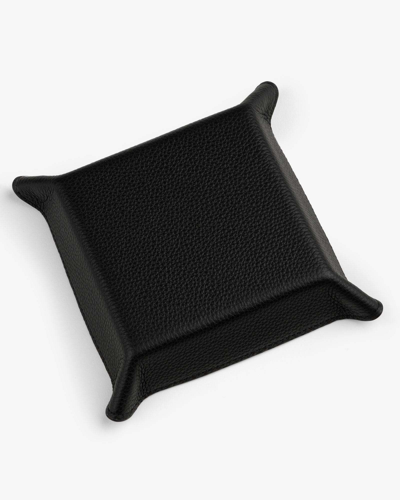 The Leather Catchall is a black leather valet tray with raised edges and pointed corners on a white background.