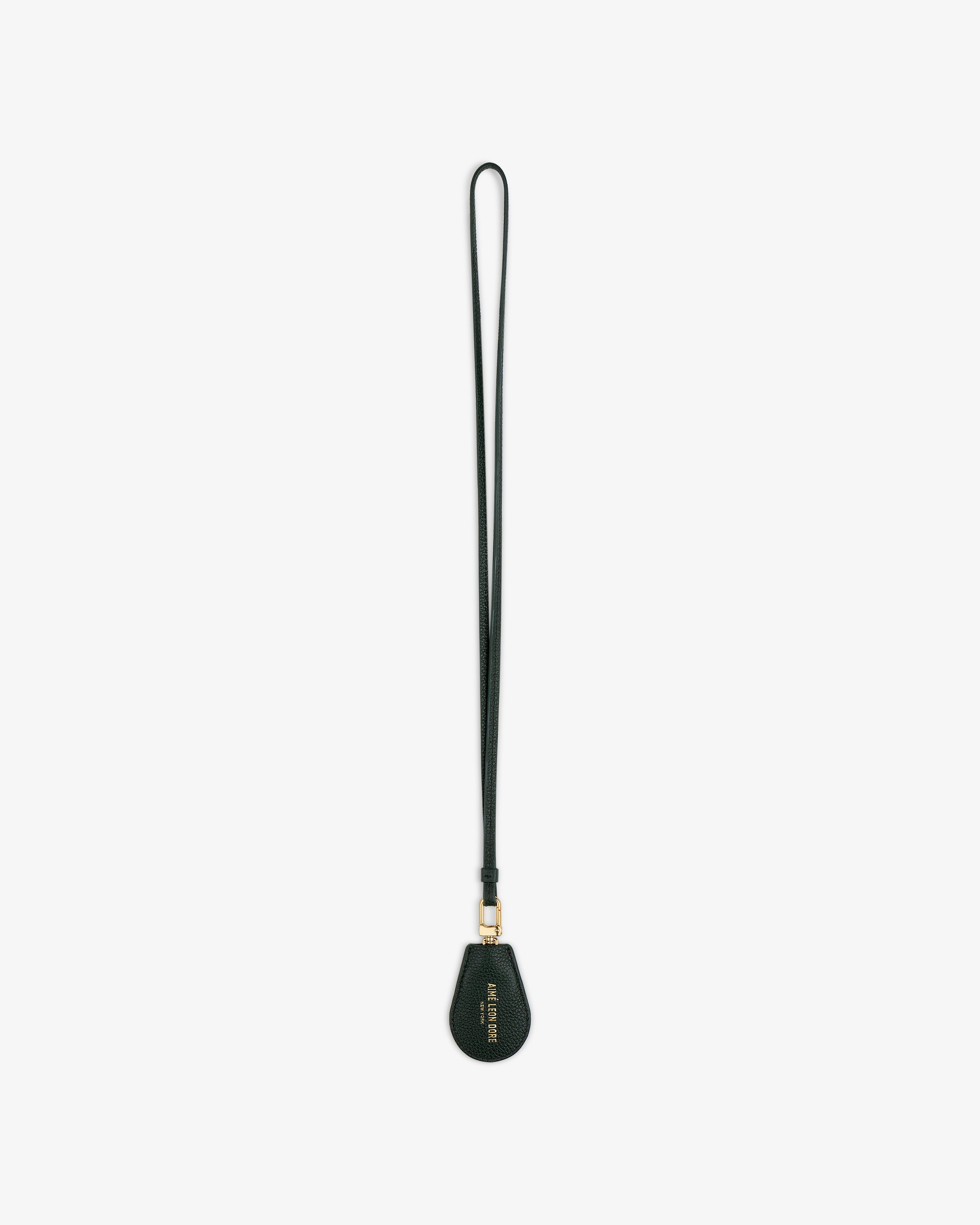 A black Leather Key Cover with a teardrop-shaped tag and gold hardware, shown on a white background.