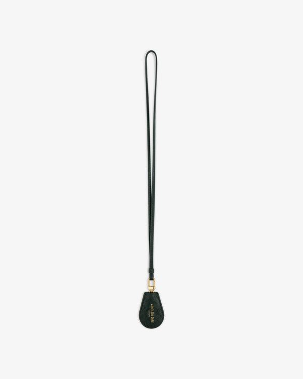 A black Leather Key Cover with a teardrop-shaped tag and gold hardware, shown on a white background.