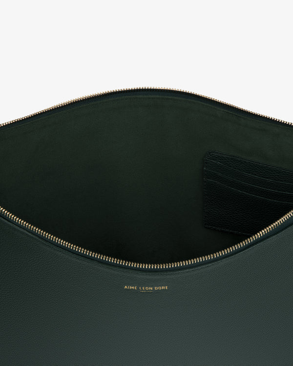 Large Leather Pouch in dark green leather with gold zipper, interior pocket, and gold Aime Leon Dore logo.