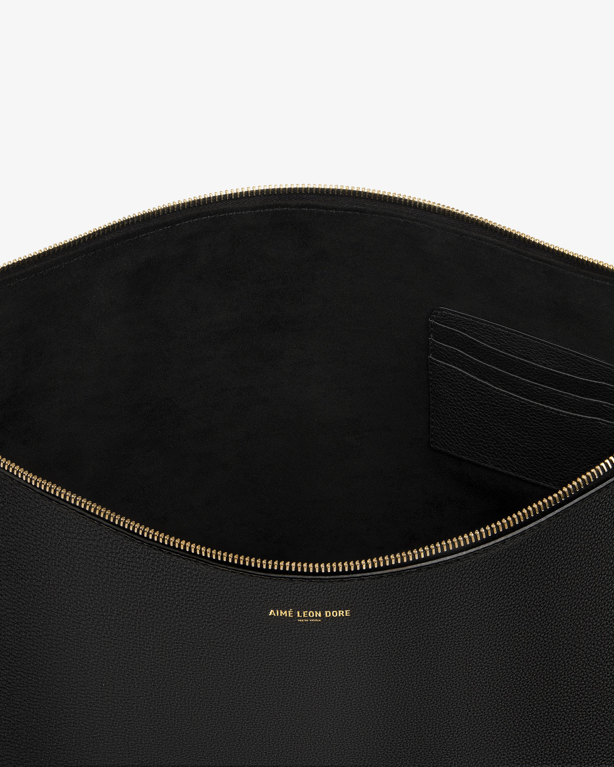 Large Leather Pouch in black leather with gold zipper, card slots, and gold AIME LEON DORE logo text inside.