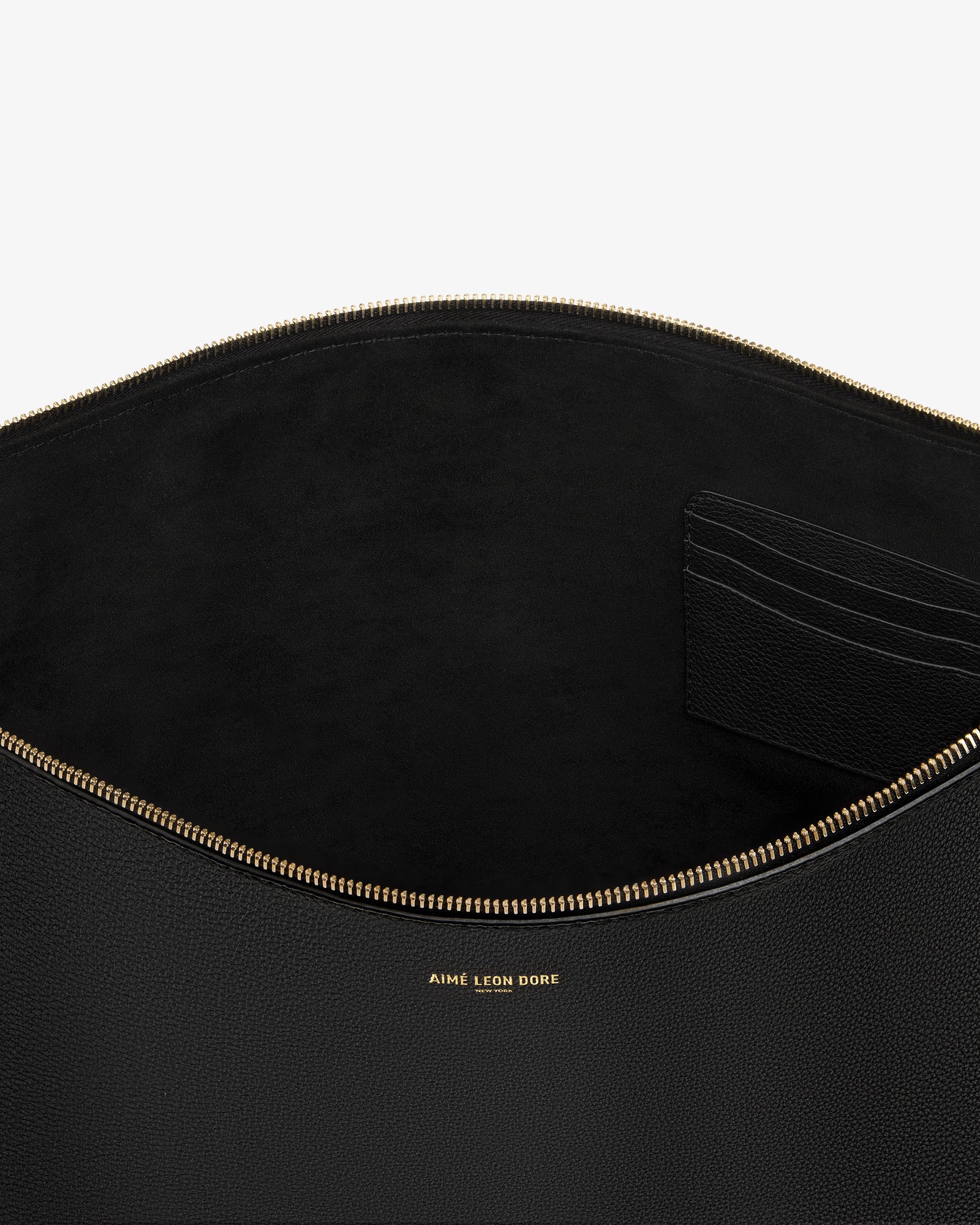 Large Leather Pouch in black leather with gold zipper, card slots, and gold AIME LEON DORE logo text inside.