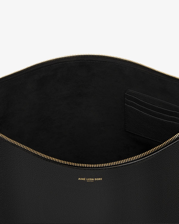 Large Leather Pouch in black leather with gold zipper, card slots, and gold AIME LEON DORE logo text inside.