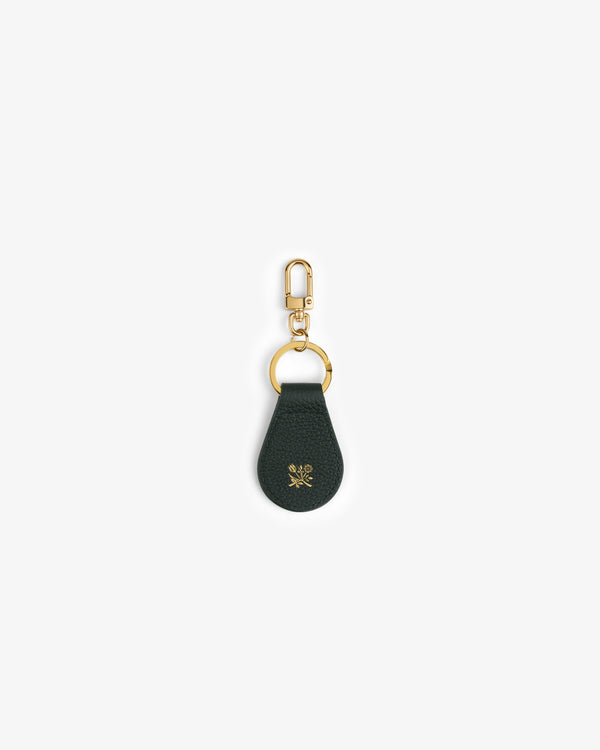 Leather Key Fob in dark green with gold hardware and a small gold flower emblem on the leather.