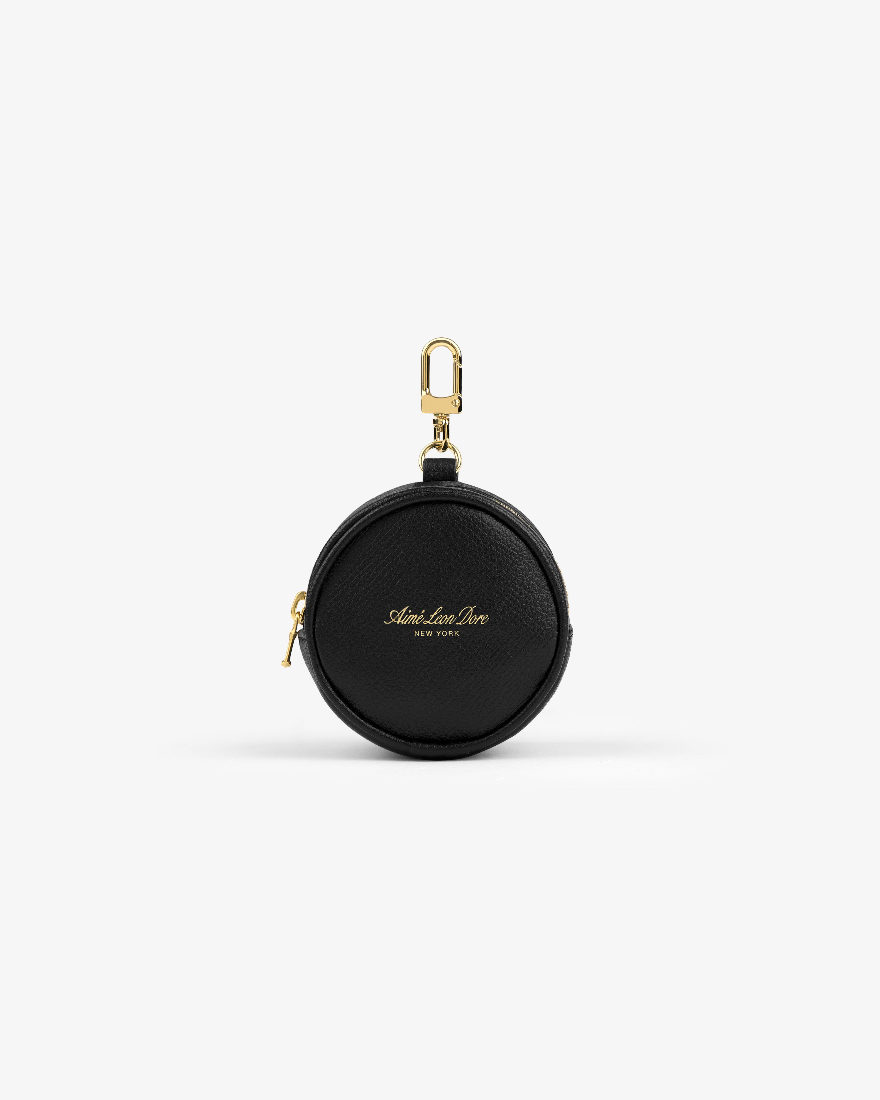 Round black Full Grain Leather Keychain Pouch with gold zipper, clip, and "Alex Lani New York" text on the front.