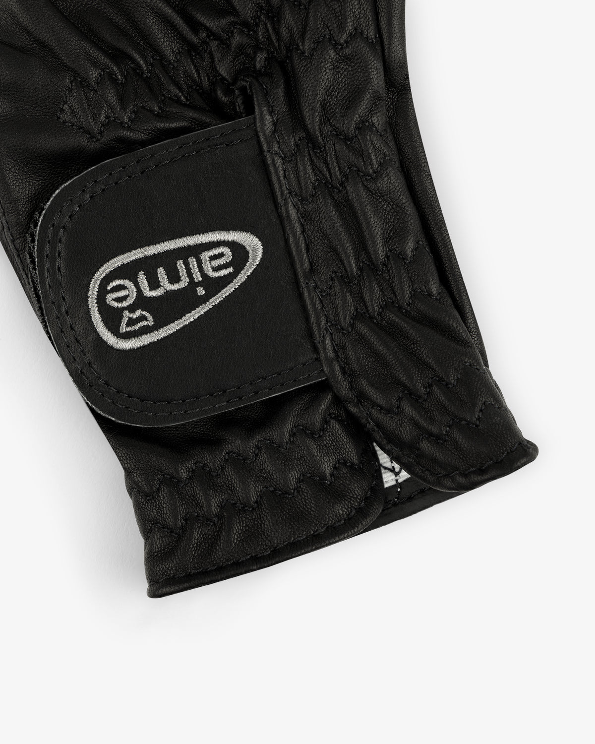 Close-up of the ALD / FootJoy StaSof Heritage Glove (Right) in black leather with visible stitching and velcro strap.