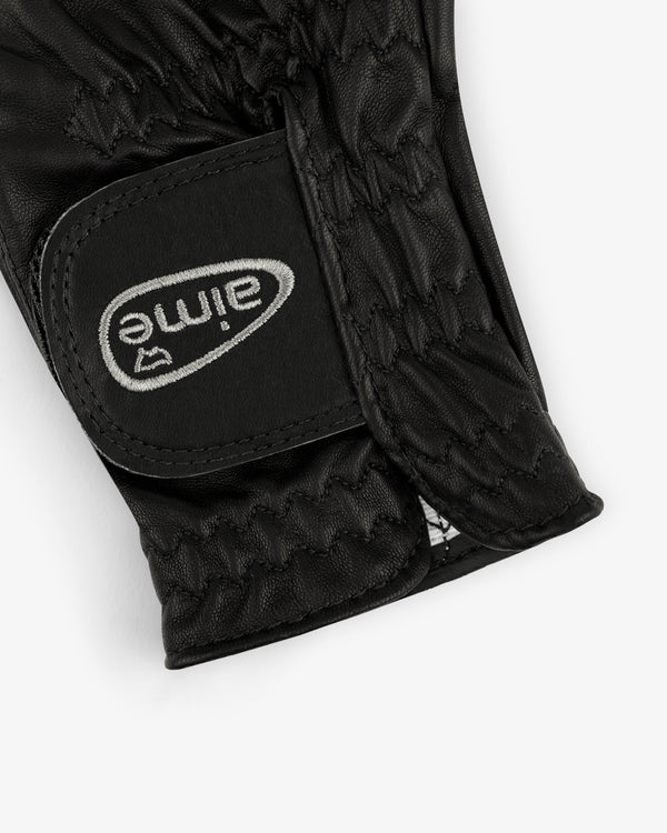 Close-up of the ALD / FootJoy StaSof Heritage Glove (Right) in black leather with visible stitching and velcro strap.