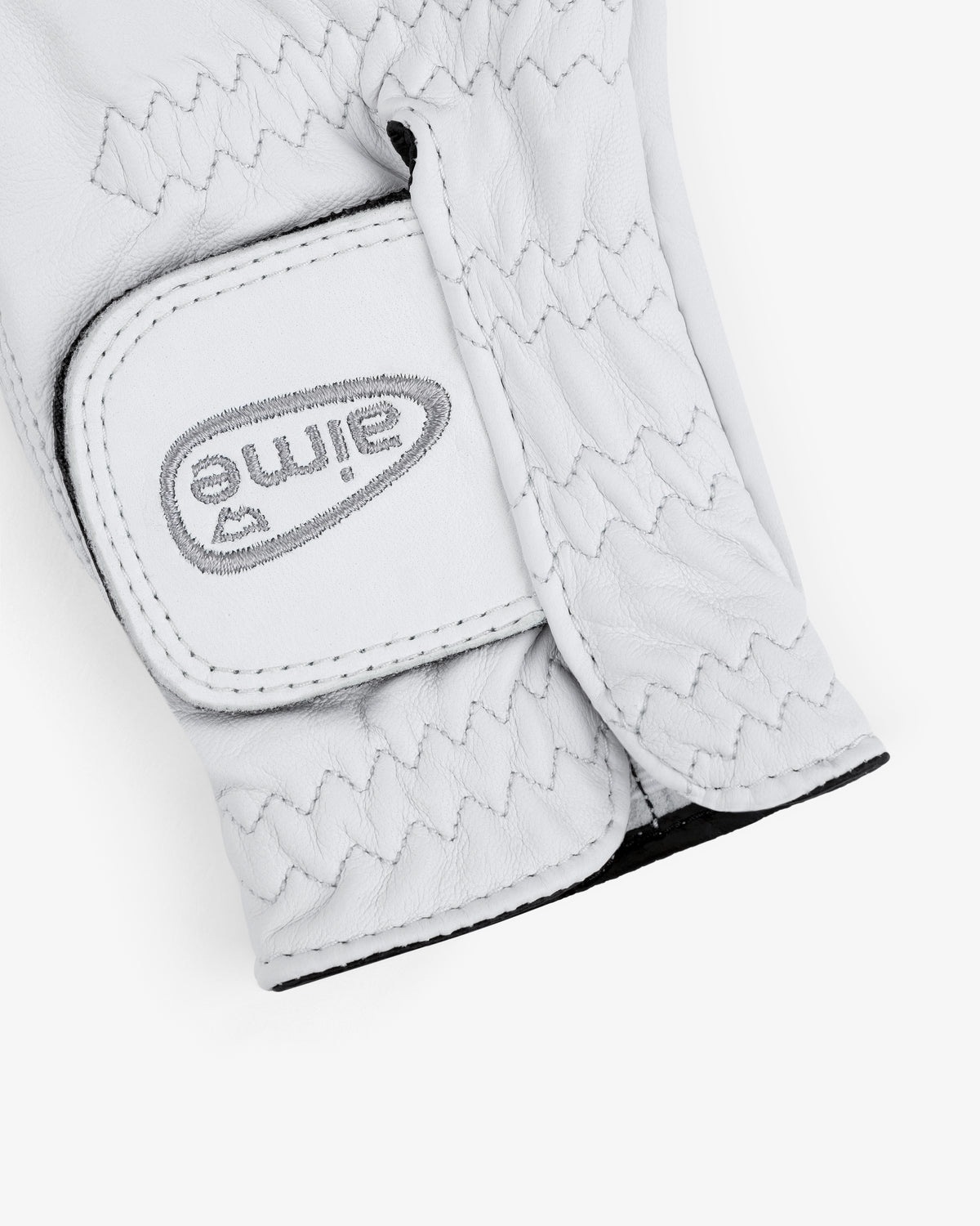 Close-up of the ALD / FootJoy StaSof Heritage Glove (Right) with "Aime" stitched upside down on the strap.