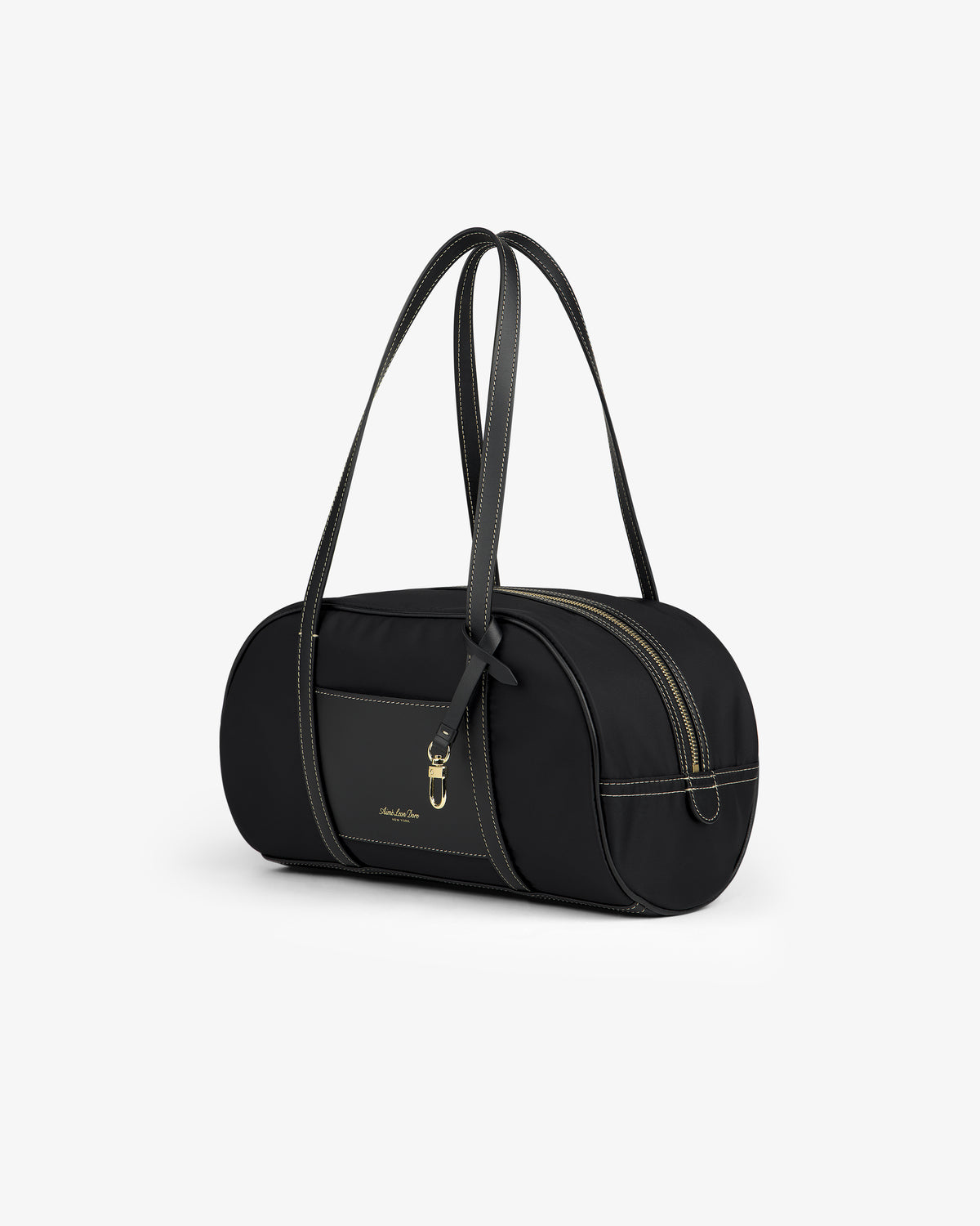 Mini Duffle Shoulder Bag—black, cylindrical with double handles, gold zipper, and gold logo on a white background.