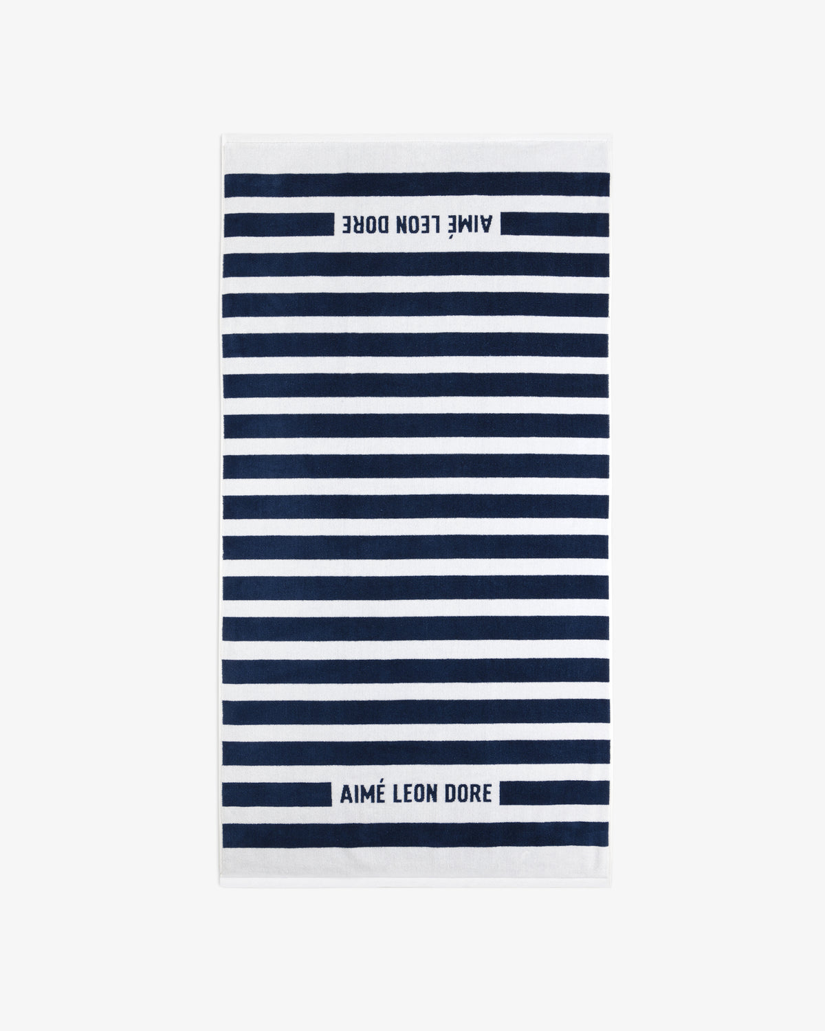 Striped Beach Towel in navy and white with AIMÉ LEON DORE text at both ends.