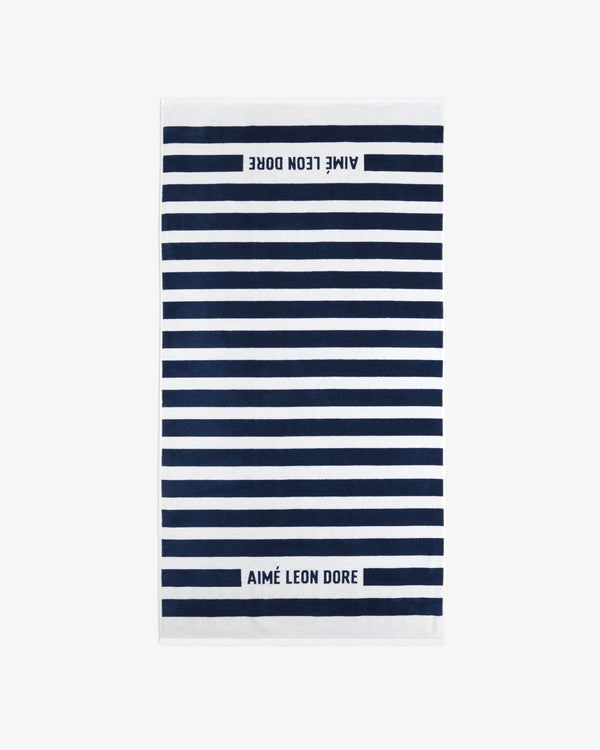 Striped Beach Towel in navy and white with AIMÉ LEON DORE text at both ends.
