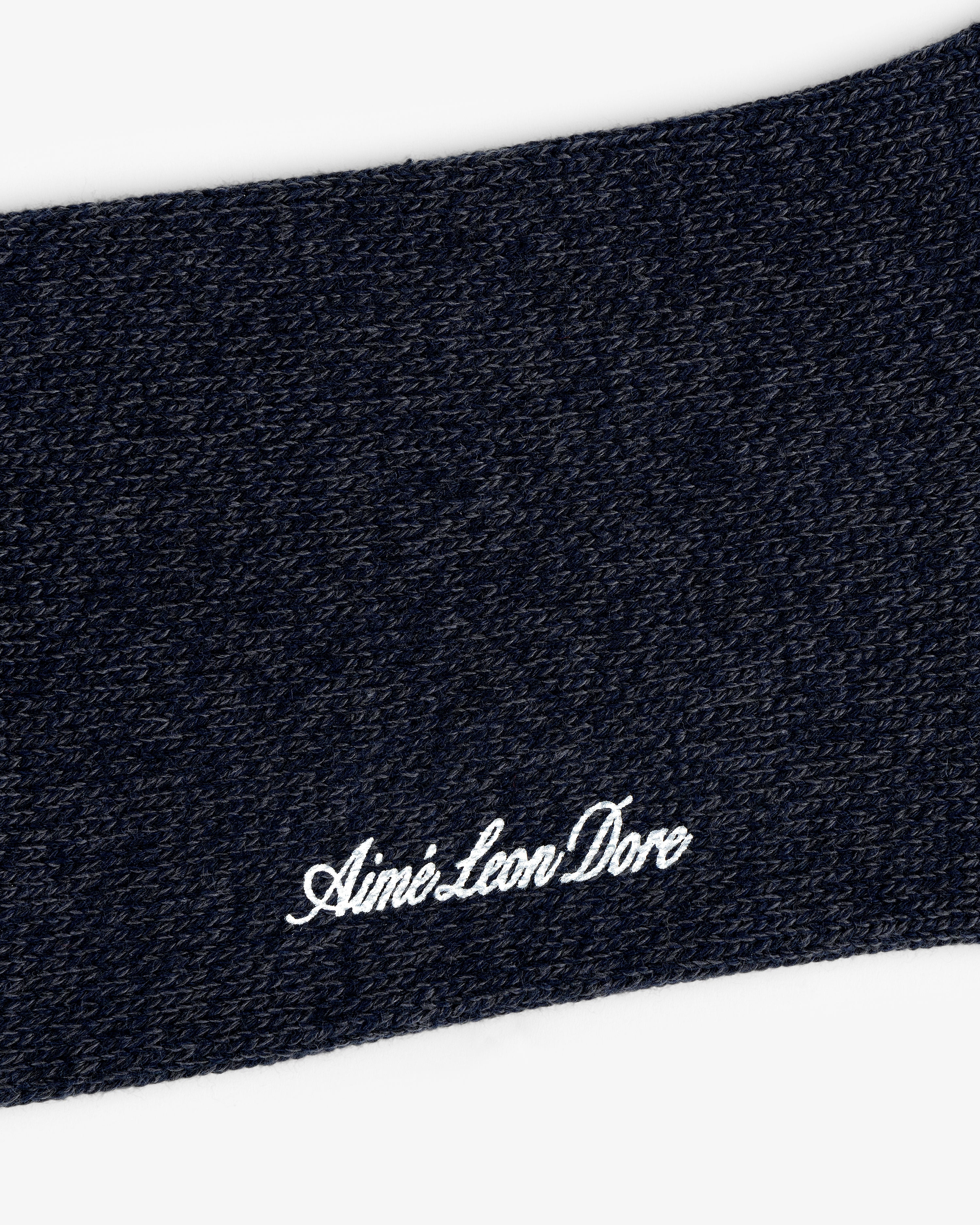 Close-up of Marled Quarter Sock knit with "Aime Leon Dore" embroidered in white cursive.