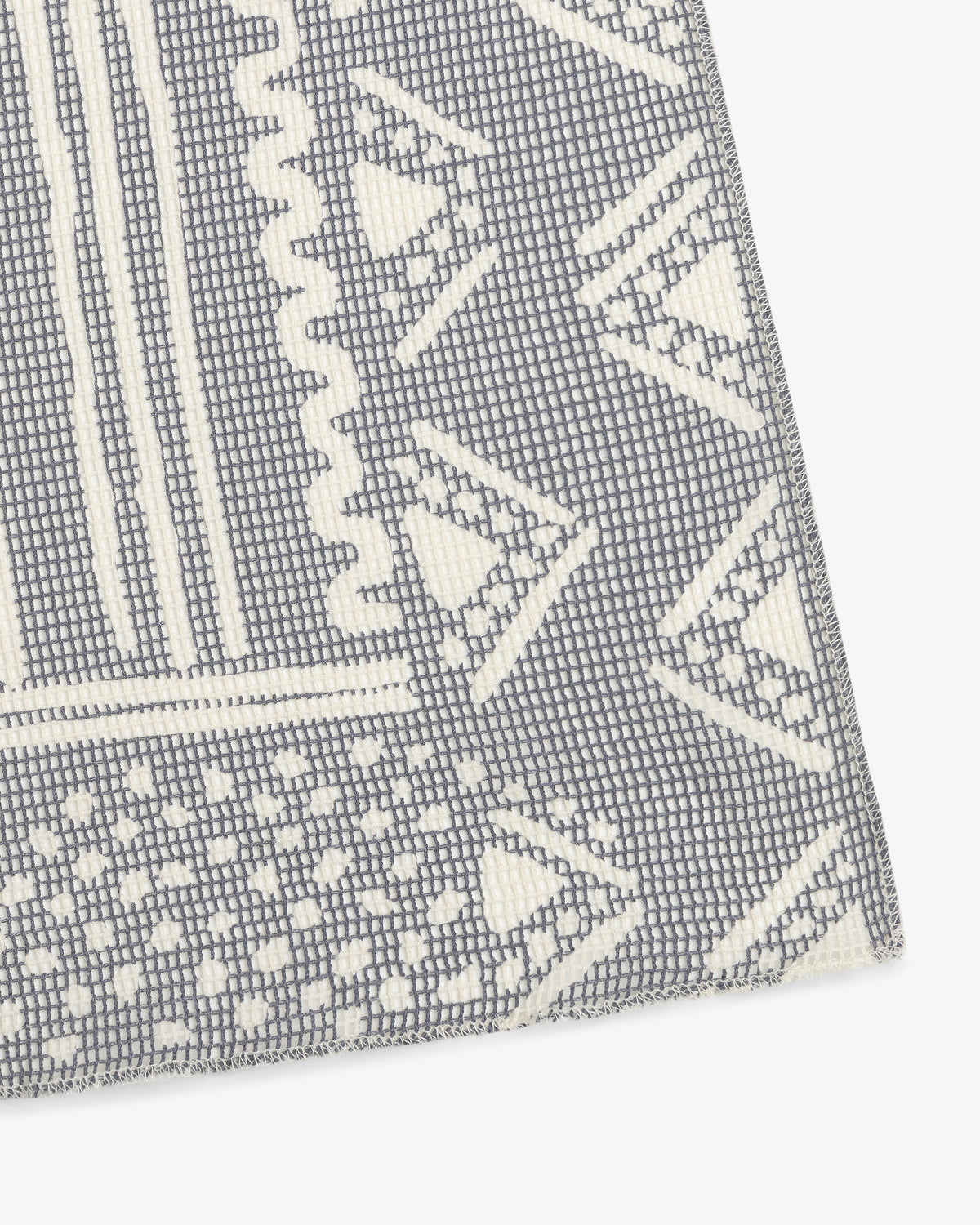 Close-up of Mesh Tapestry Bandana featuring textured gray and white fabric with geometric triangles and rectangles.