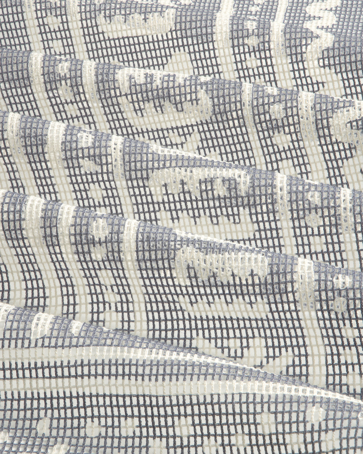 Close-up of the Mesh Tapestry Bandana featuring a geometric grid and wavy white and gray patterns.