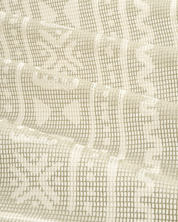 Close-up of the Mesh Tapestry Bandana in cream, showing its textured grid and floral pattern, softly folded.