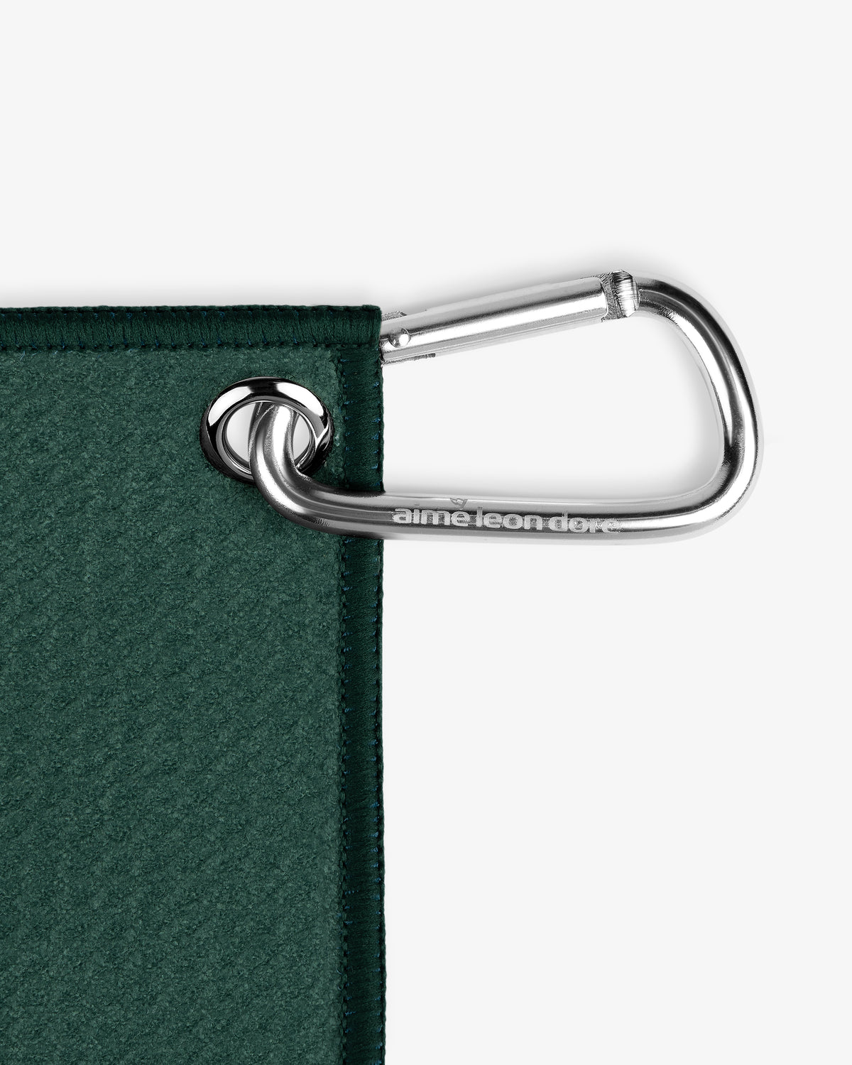 A silver carabiner clips through a metal grommet on the corner of the ALD Golf Caddy Towel.