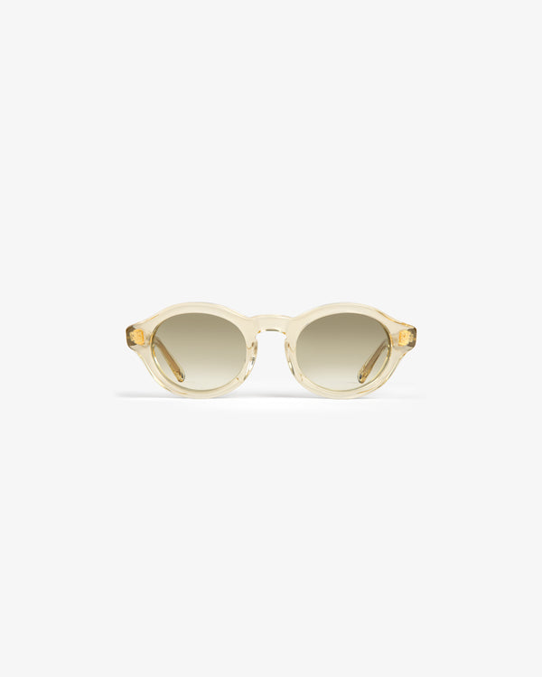 Onásis Sunglasses: Translucent, round light beige frames with gradient tinted lenses on a white background.