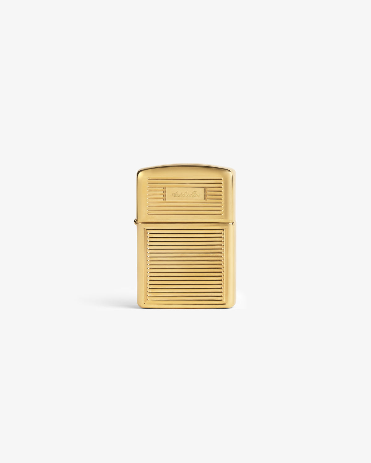 A brass Zippo lighter with a ridged body and smooth lid stands upright on a white background.