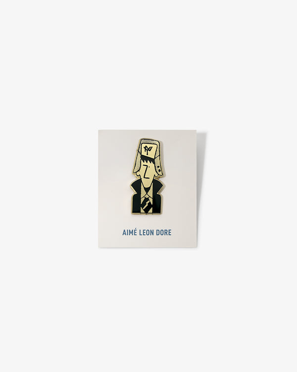 Graphic Pin featuring a cartoon person in a suit and hat, displayed on AIMÉ LEON DORE branded card.