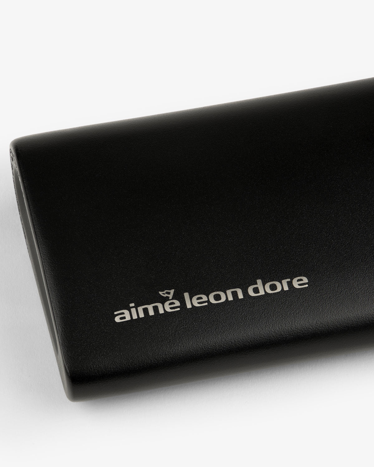 Black leather ALD Golf 19th Flask case featuring the aime leon dore logo in white on the front.