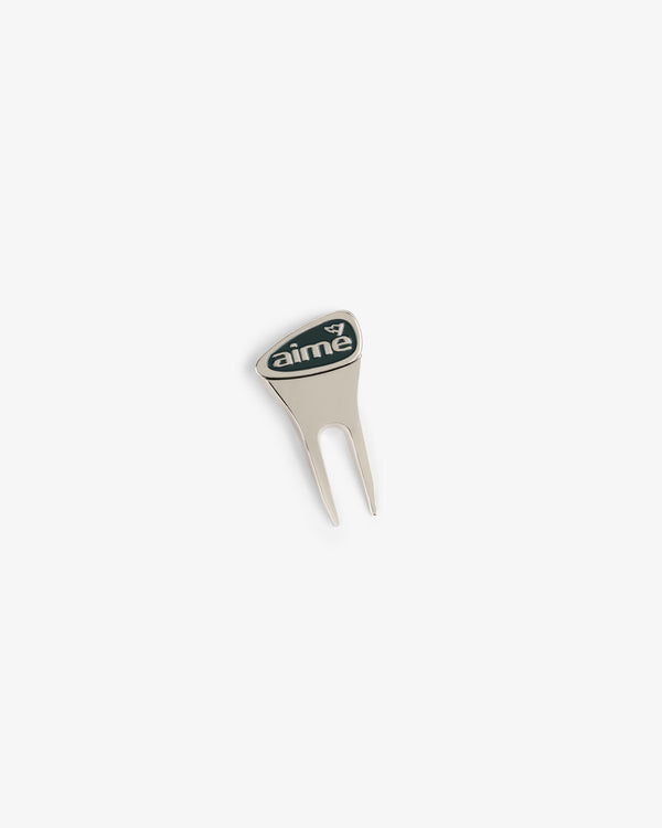 The ALD Golf Divot Tool is silver with a black aime logo on the handle, displayed on a white background.