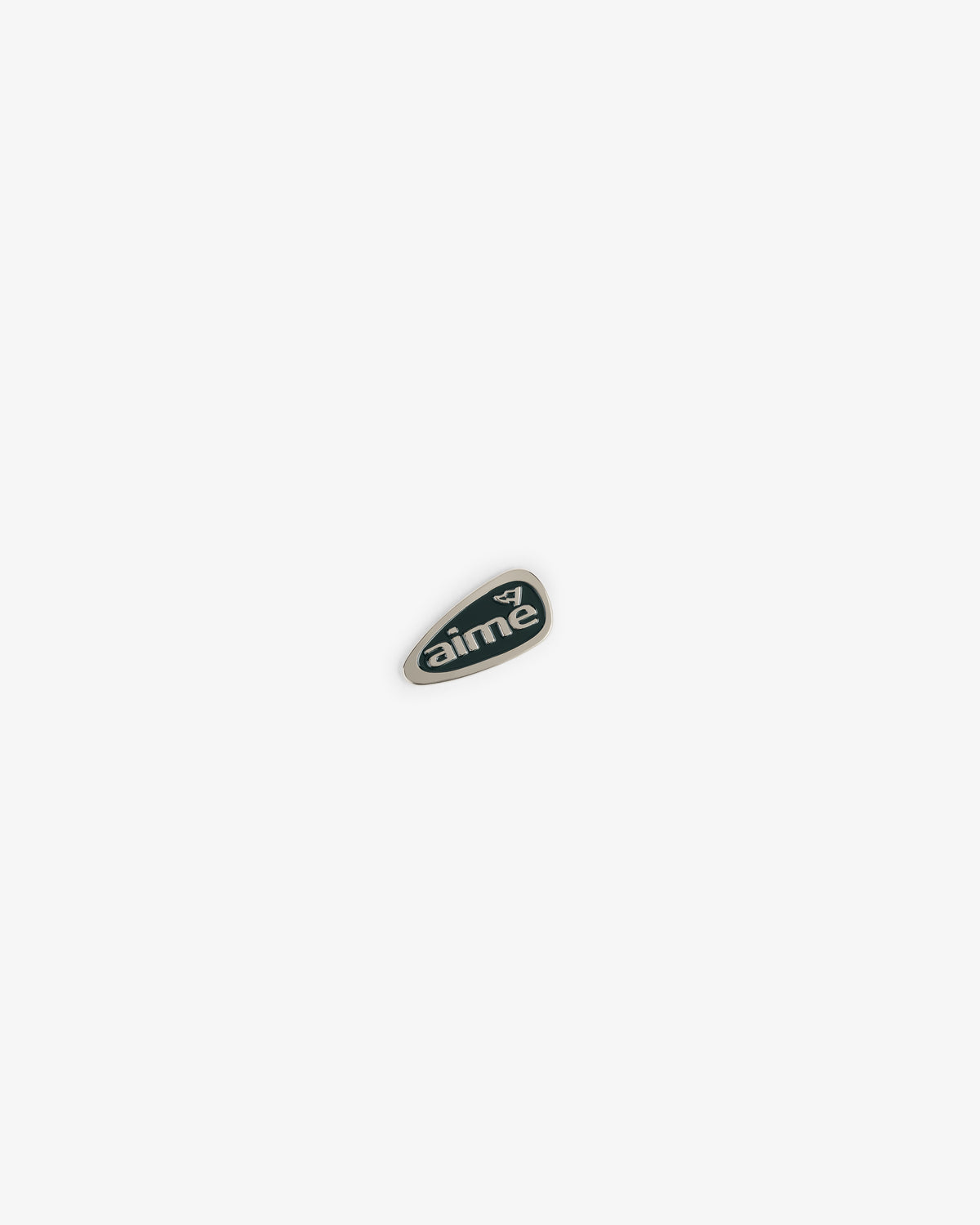 A small, dark green ALD Golf Divot Tool with "aimé" and a white graphic, centered on a white background.