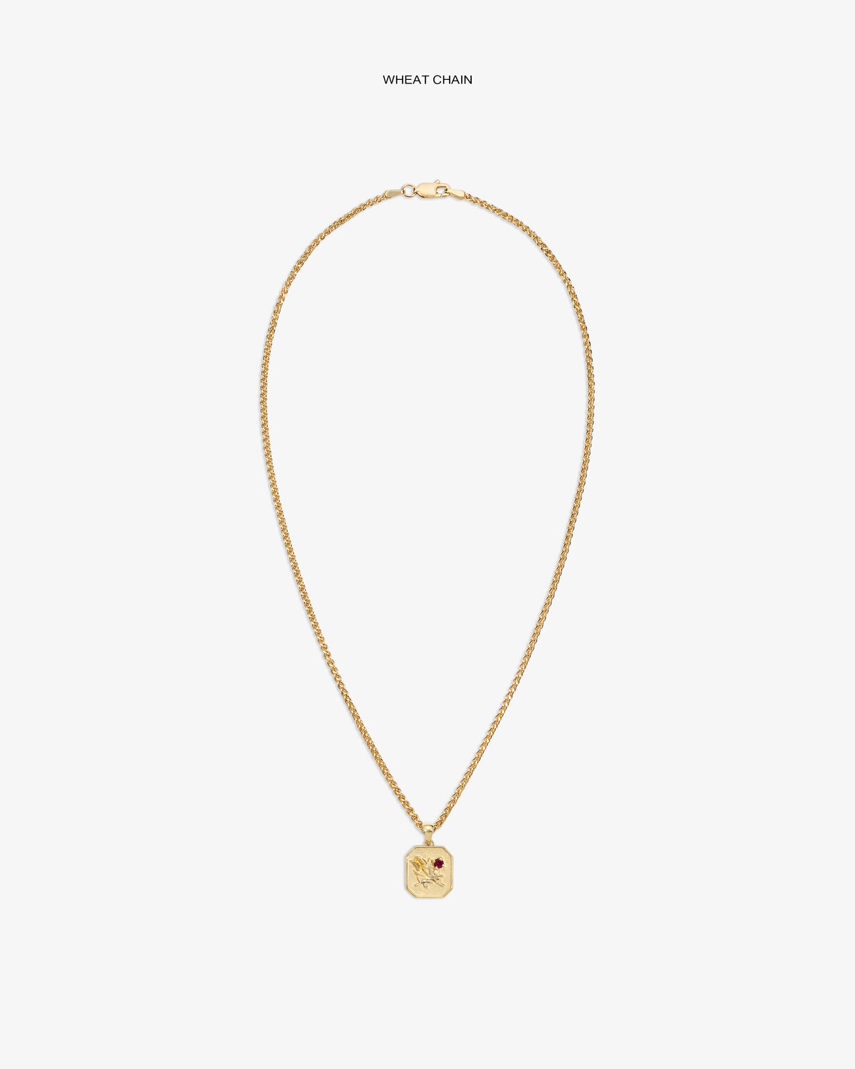 14Kt gold wheat chain necklace with Queens Crest Relief pendant and a small red gem accent.