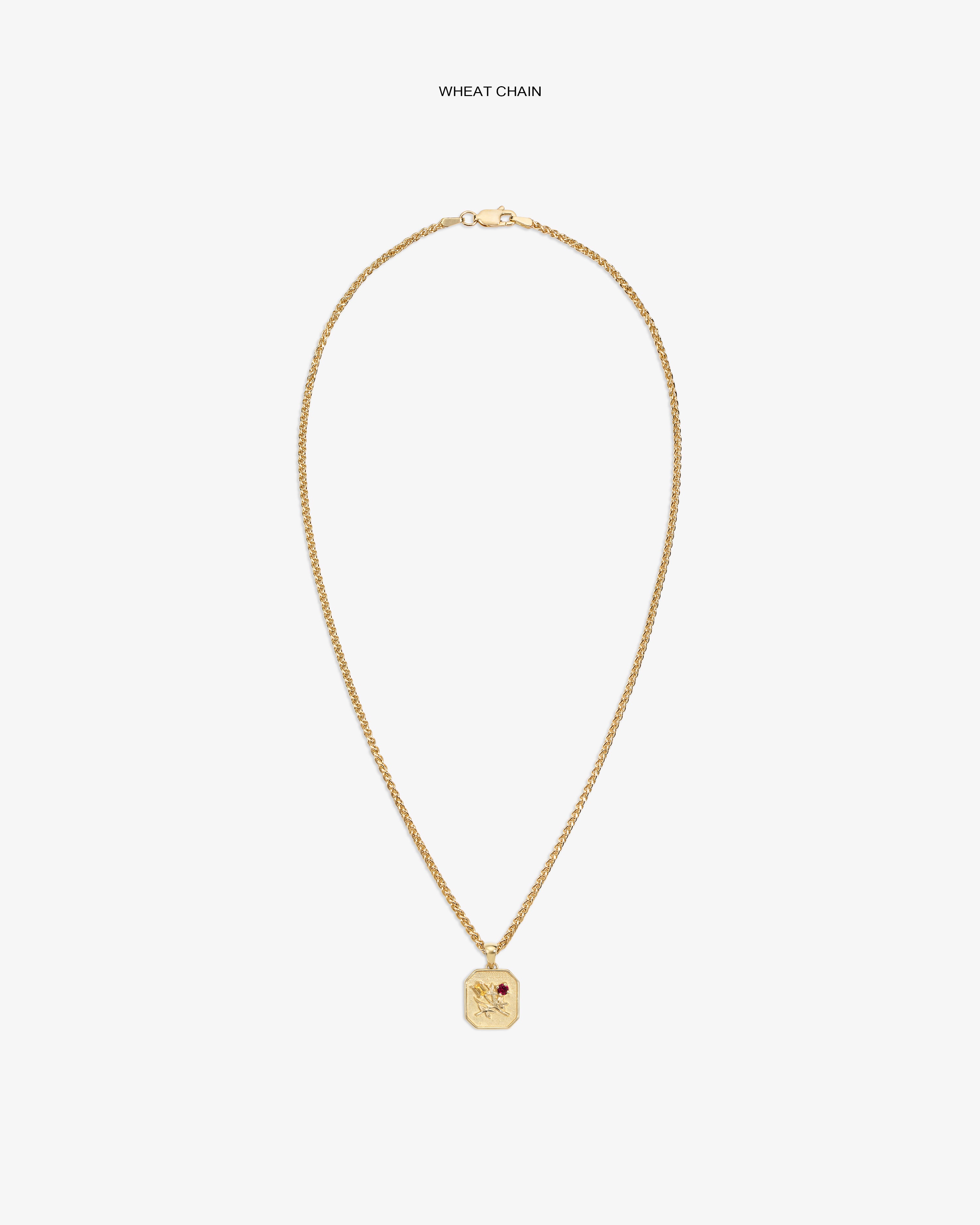 14Kt gold wheat chain necklace with Queens Crest Relief pendant and a small red gem accent.