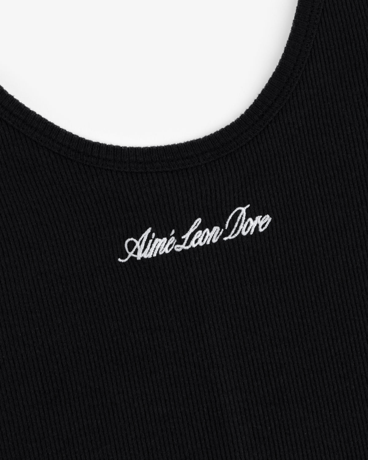 Close-up of a black ribbed Embroidered Logo Tank Dress with Aimé Leon Dore stitched in white cursive.