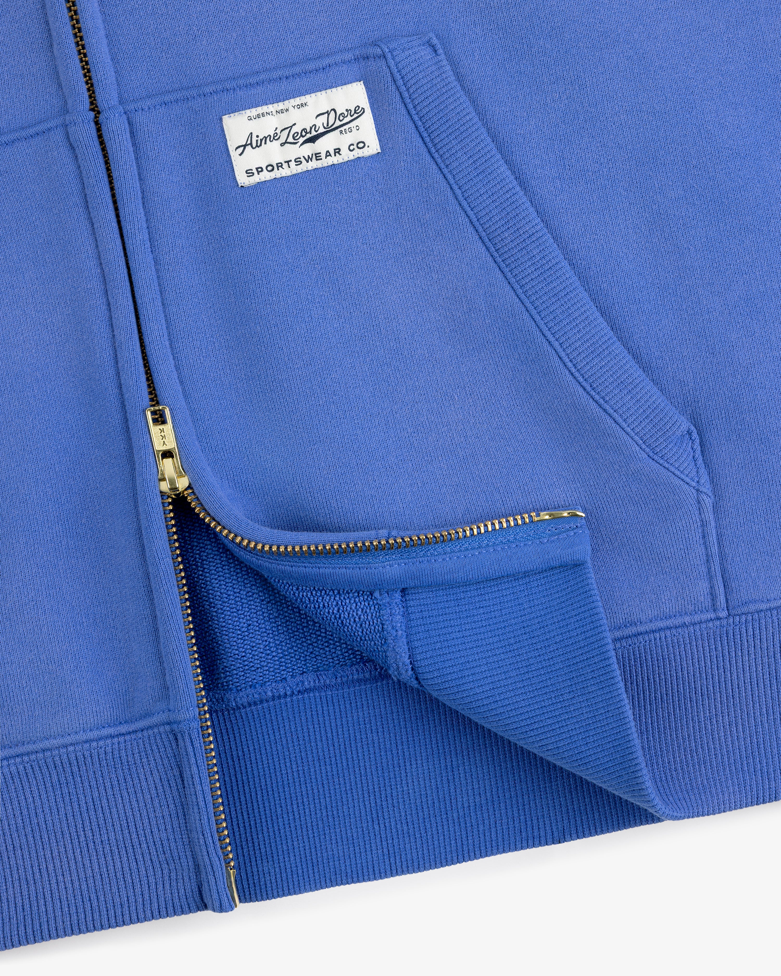 Close-up of the Sun Faded Full-Zip Hoodie highlighting its zipper, pocket, and chest sportswear label.