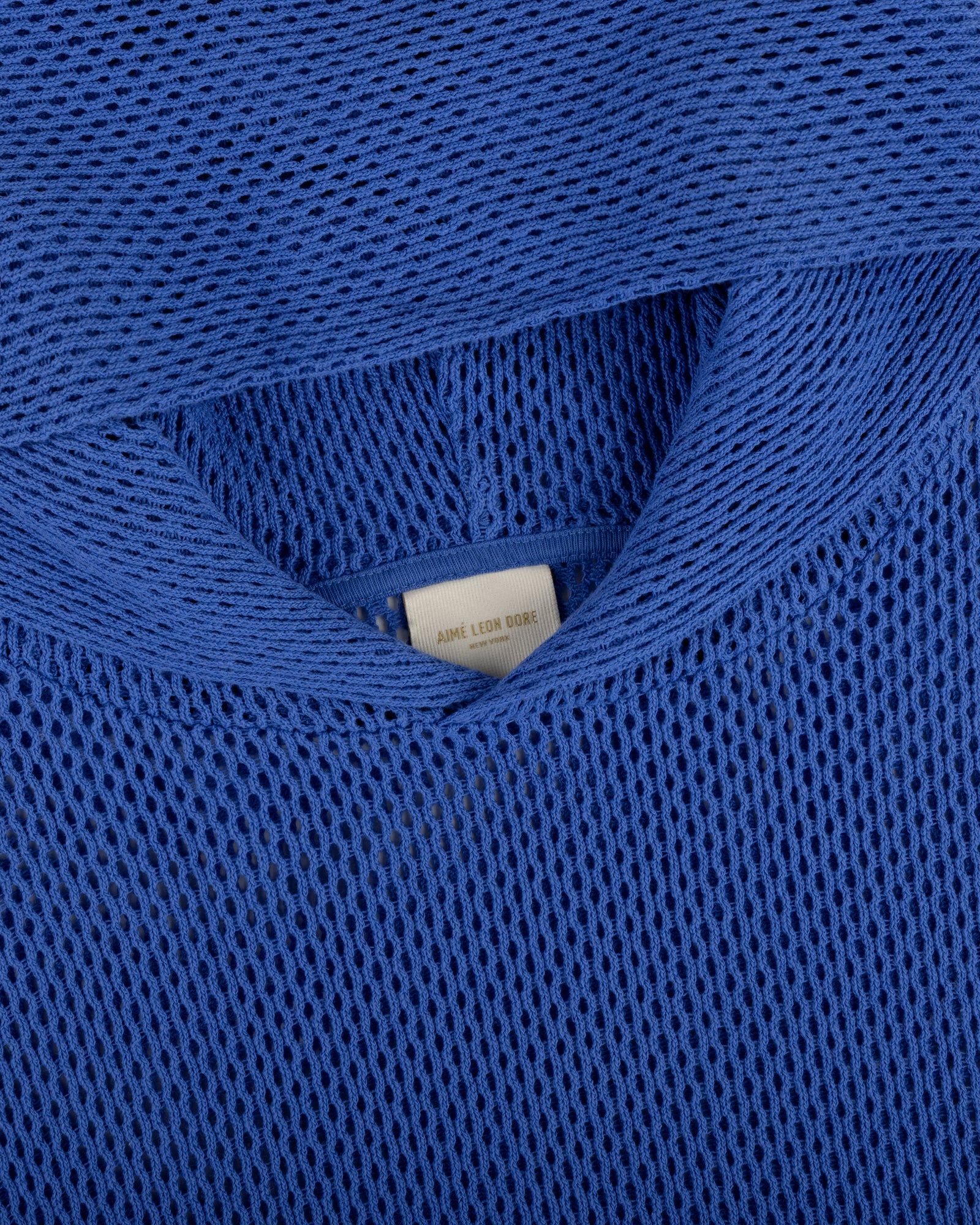 Close-up of an Open Mesh Hoodie in blue with a visible white clothing label inside the neckline.