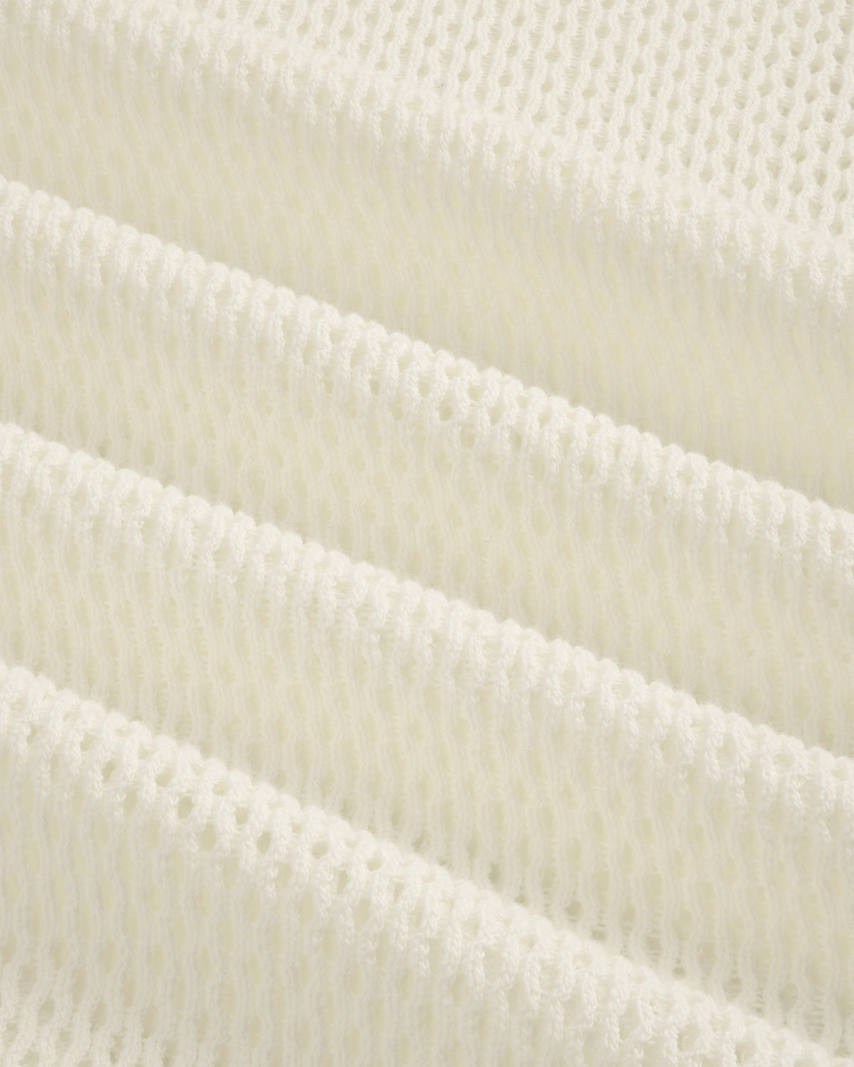 Close-up of folded, textured white Open Mesh Hoodie with a repeating open-weave pattern.