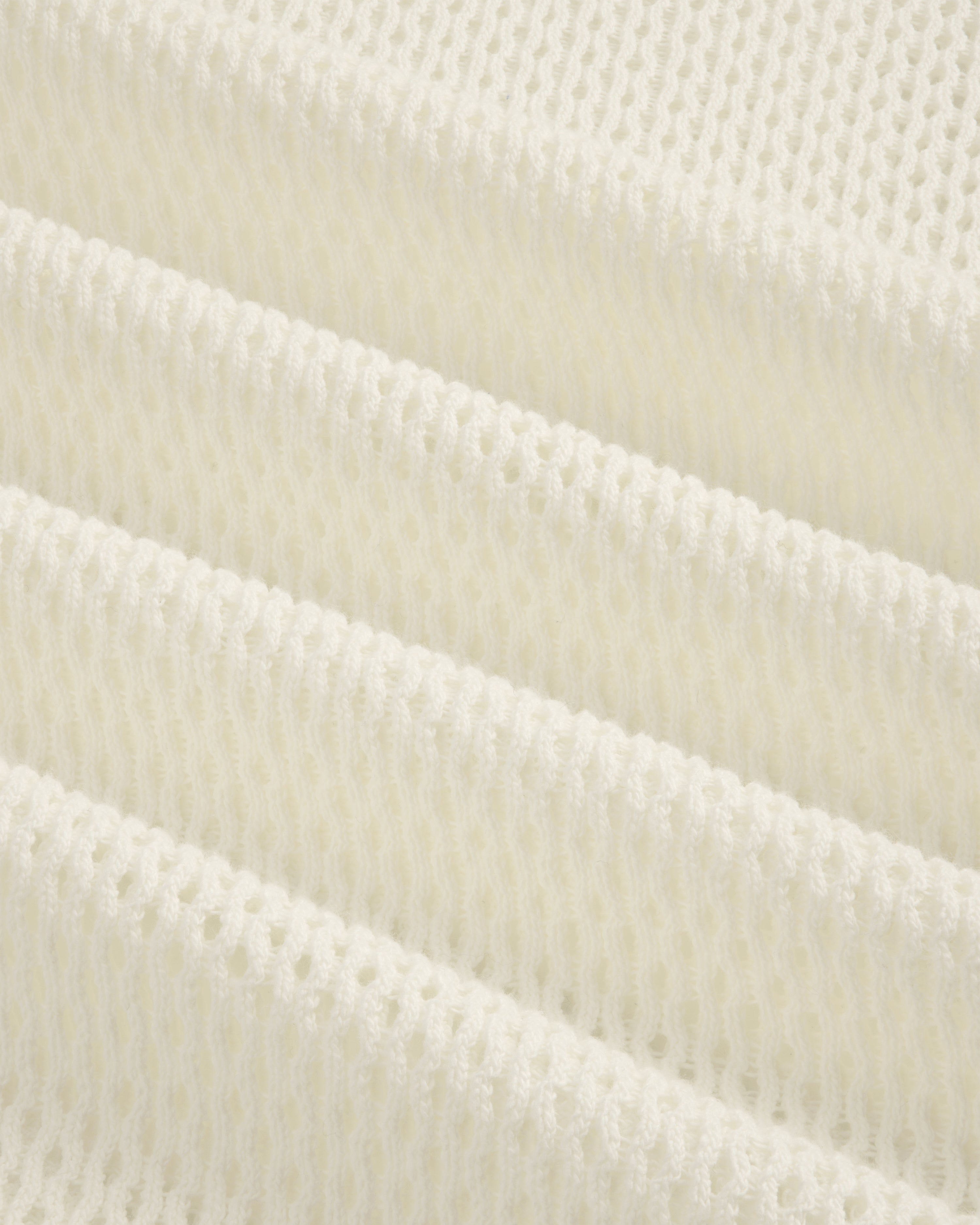Close-up of folded, textured white Open Mesh Hoodie with a repeating open-weave pattern.