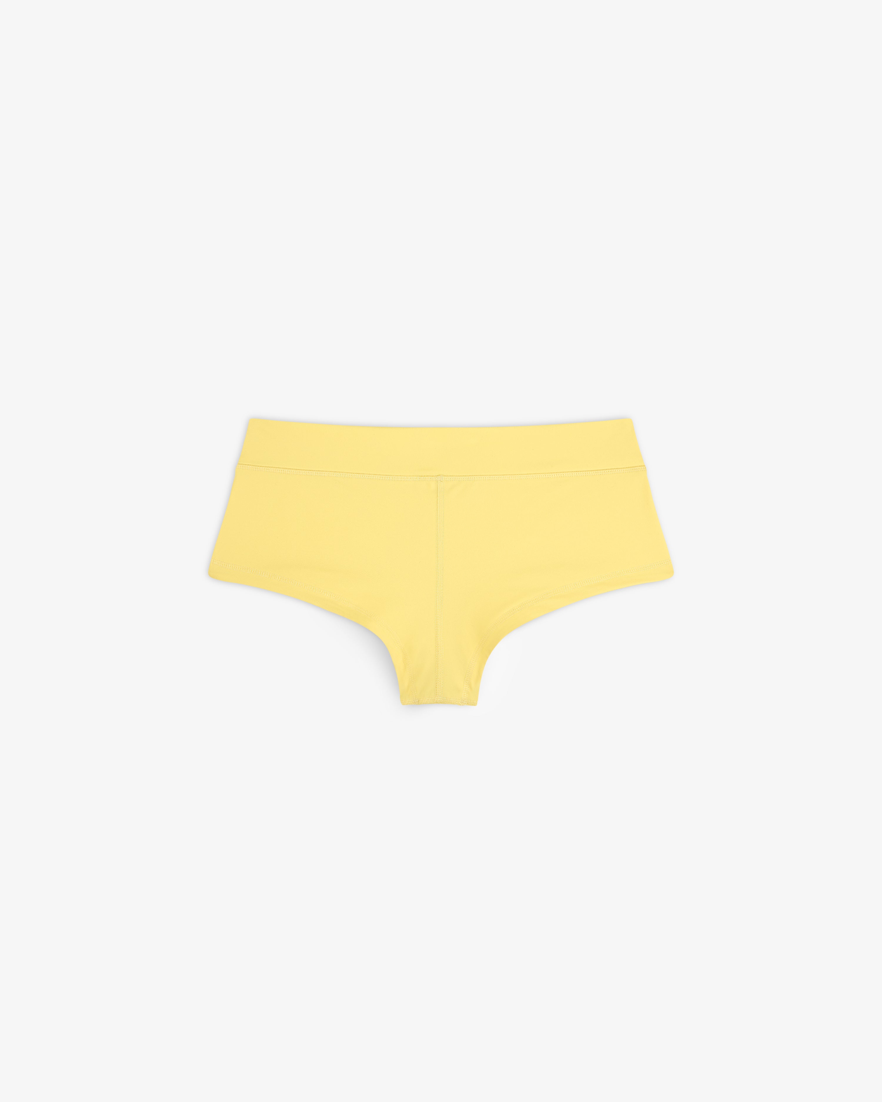 Crest Swim Short in yellow, seamless boyshort style, displayed flat on a white background.