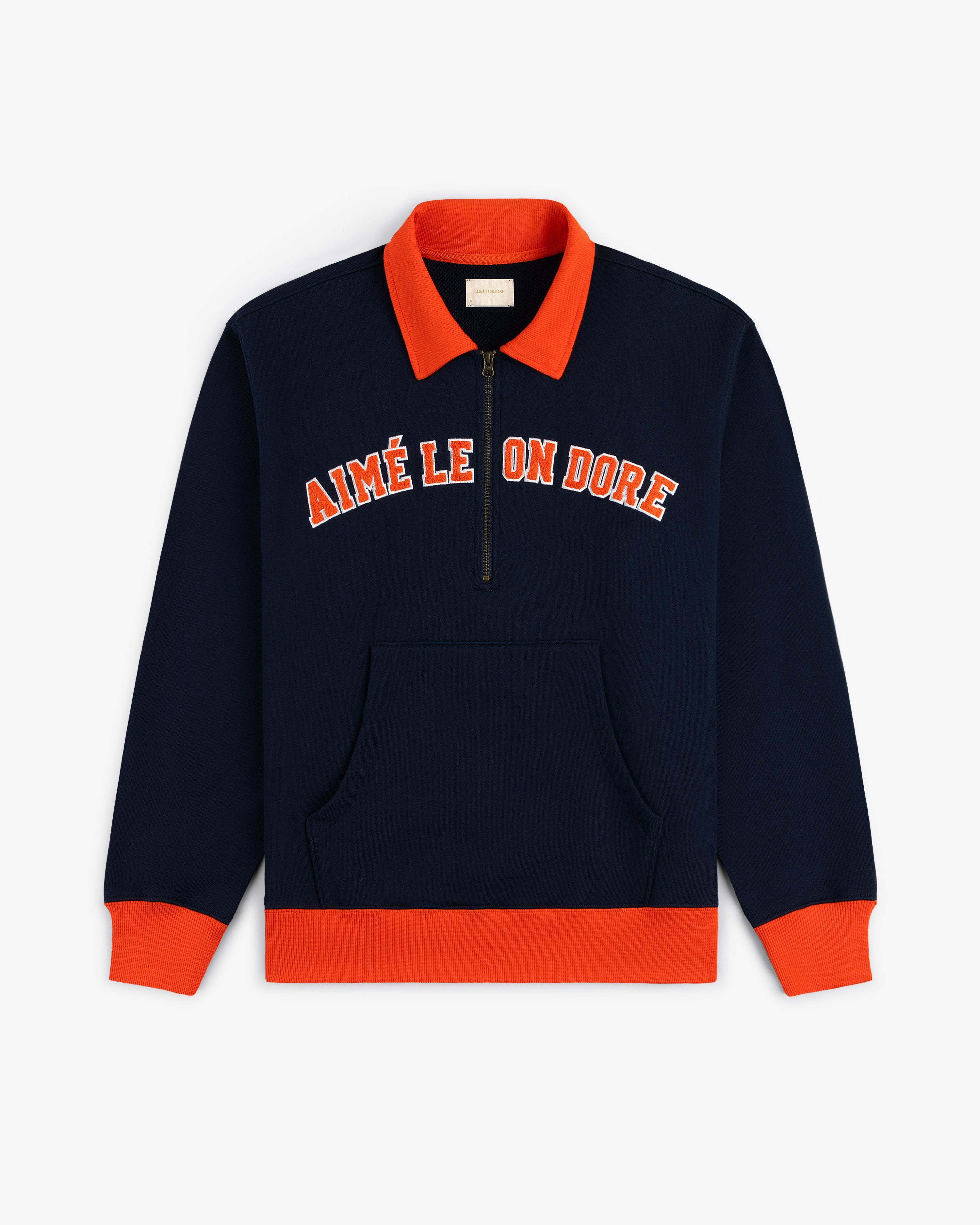 Collegiate Quarter Zip Pullover in navy with orange accents, front pocket, half-zip, and AIMÉ LEON DORÉ chest text.