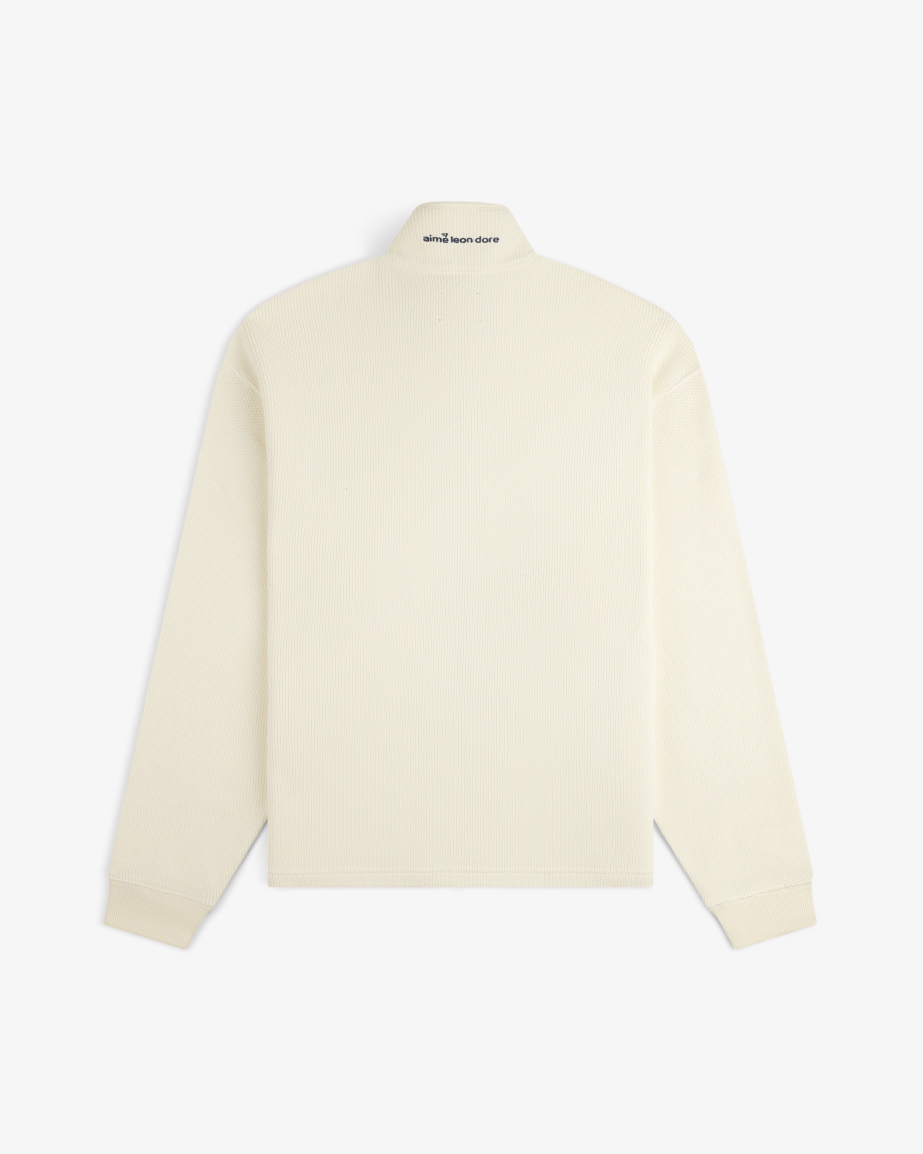 Back view of ALD Golf Piqué Full Zip Sweater, off-white with ribbed texture and small text on upper collar.