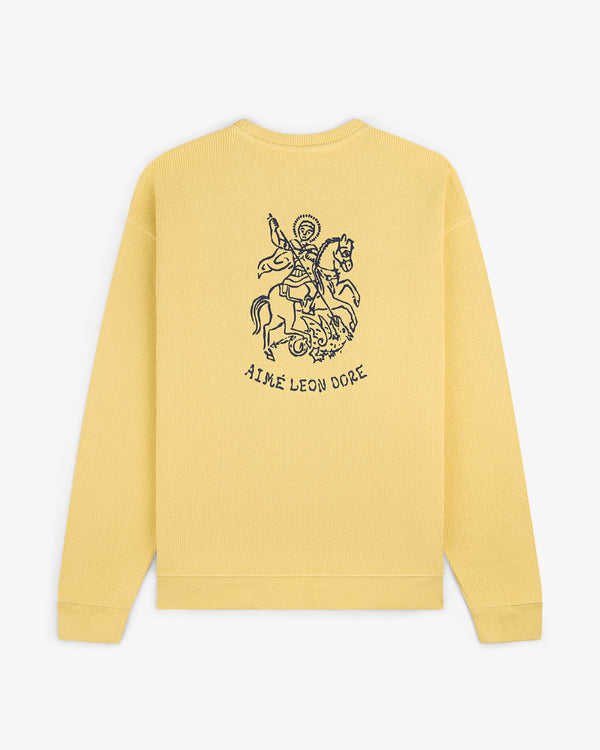 Yellow Saint George Piqué Crewneck Sweatshirt with horse rider line art and AIME LEON DORE on the back.