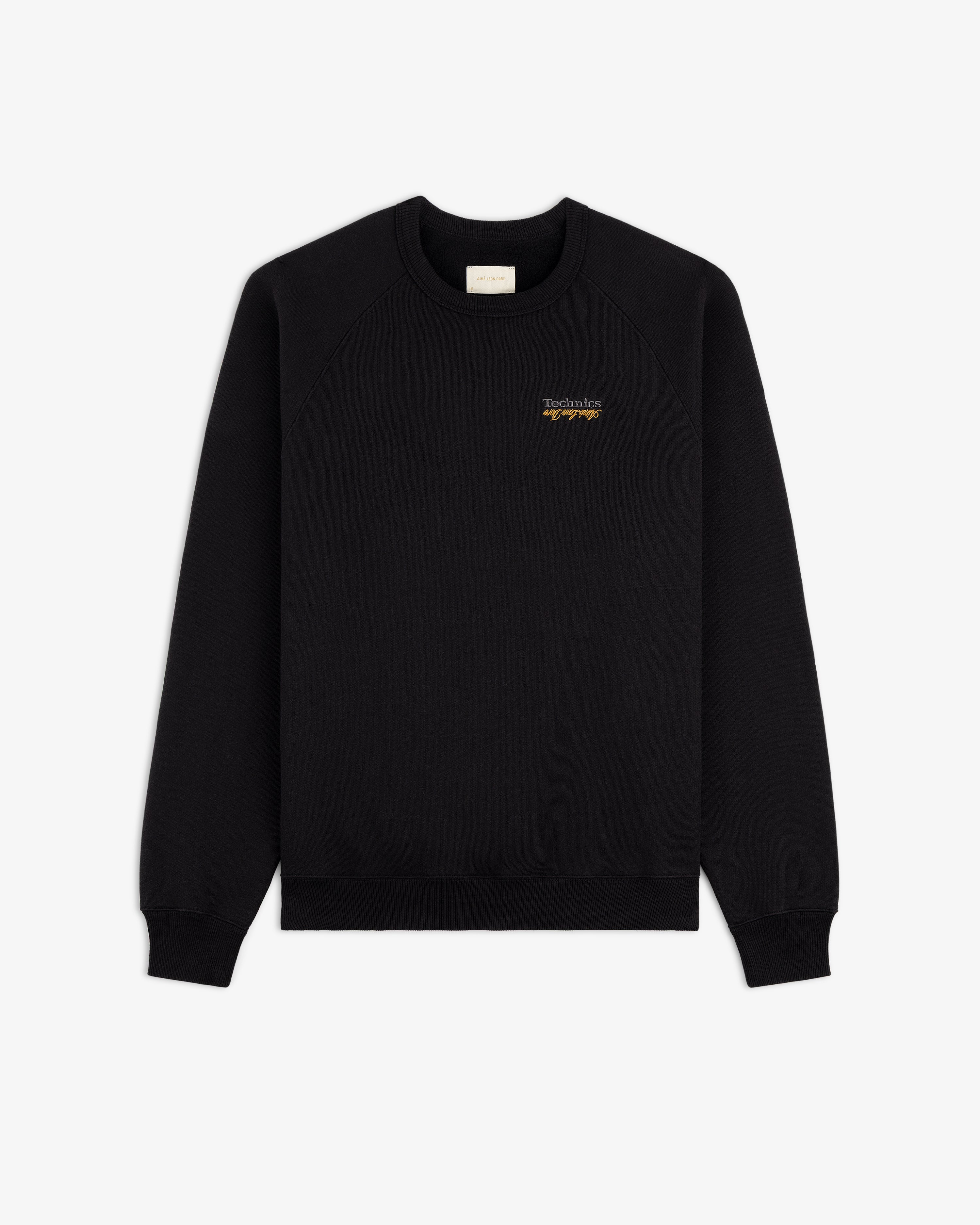 ALD / Technics World Champions Crewneck in black with small yellow chest text, shown on a white background.