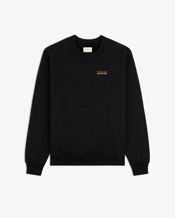 ALD / Technics World Champions Crewneck in black with small yellow chest text, shown on a white background.