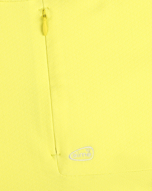 Close-up of ALD Golf Quarter Zip Pullover in yellow with textured fabric, zip pocket, and embroidered white aimé logo.