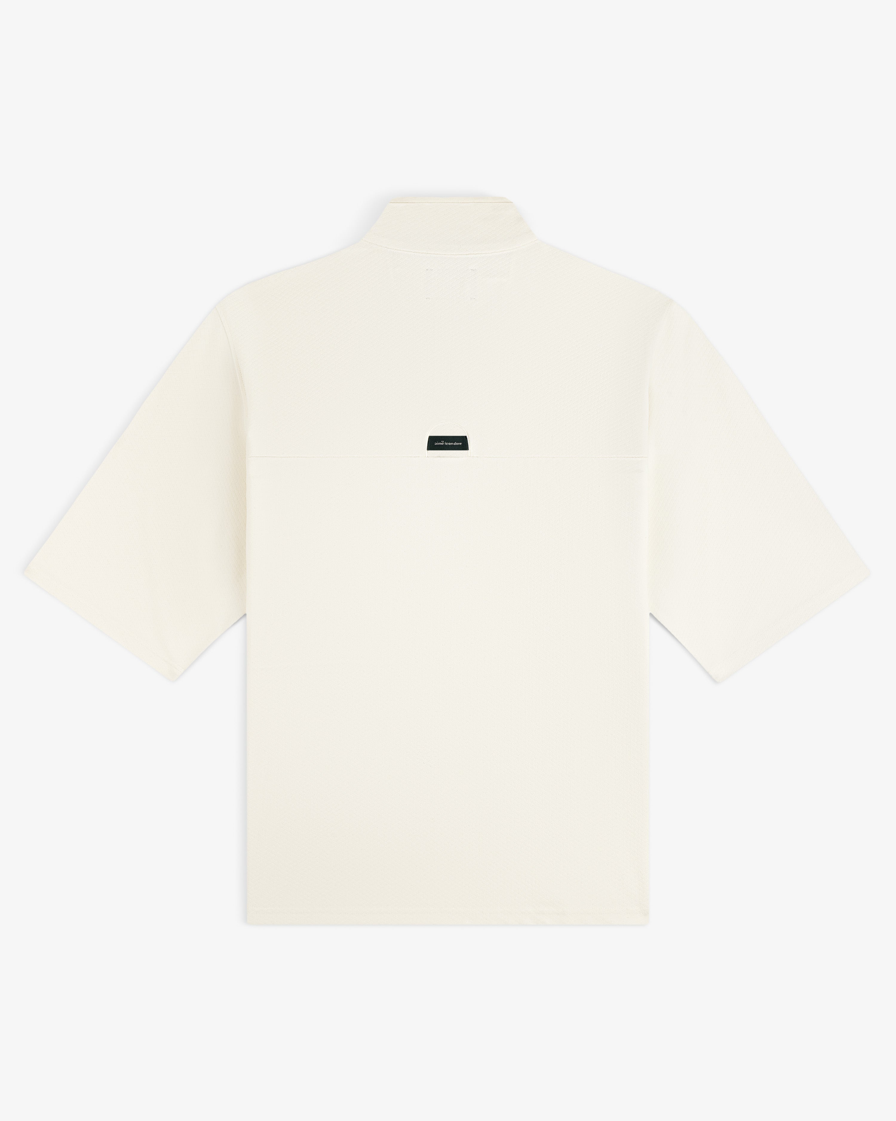 Back view of the ALD Golf Quarter Zip Pullover in off-white with a small dark label at the upper center.