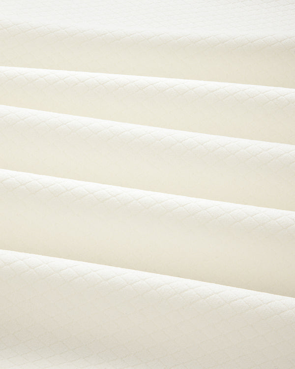 Cream-colored ALD Golf Quarter Zip Pullover in quilted fabric with a subtle diamond pattern and soft, even folds.