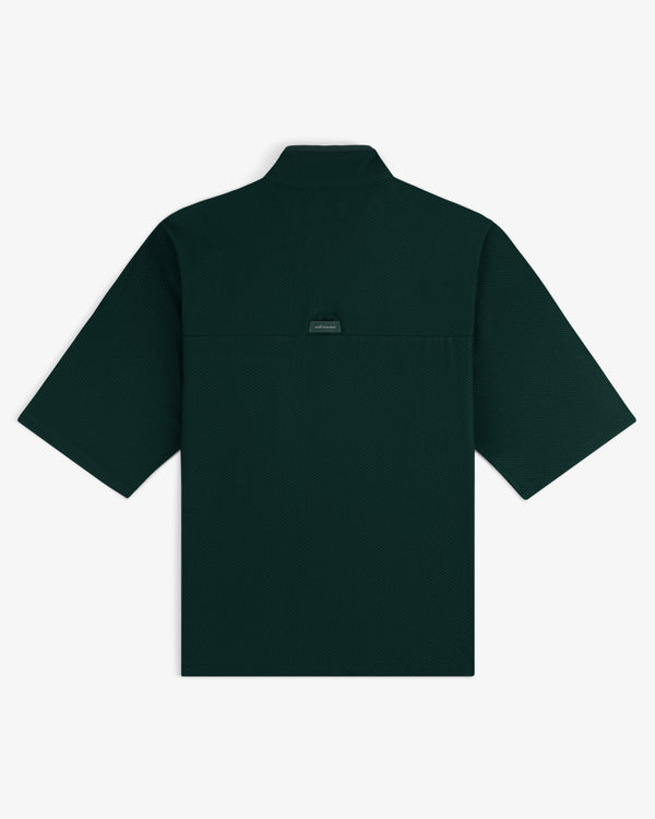 Dark green ALD Golf Quarter Zip Pullover shown from the back with a small brand tag below the collar.
