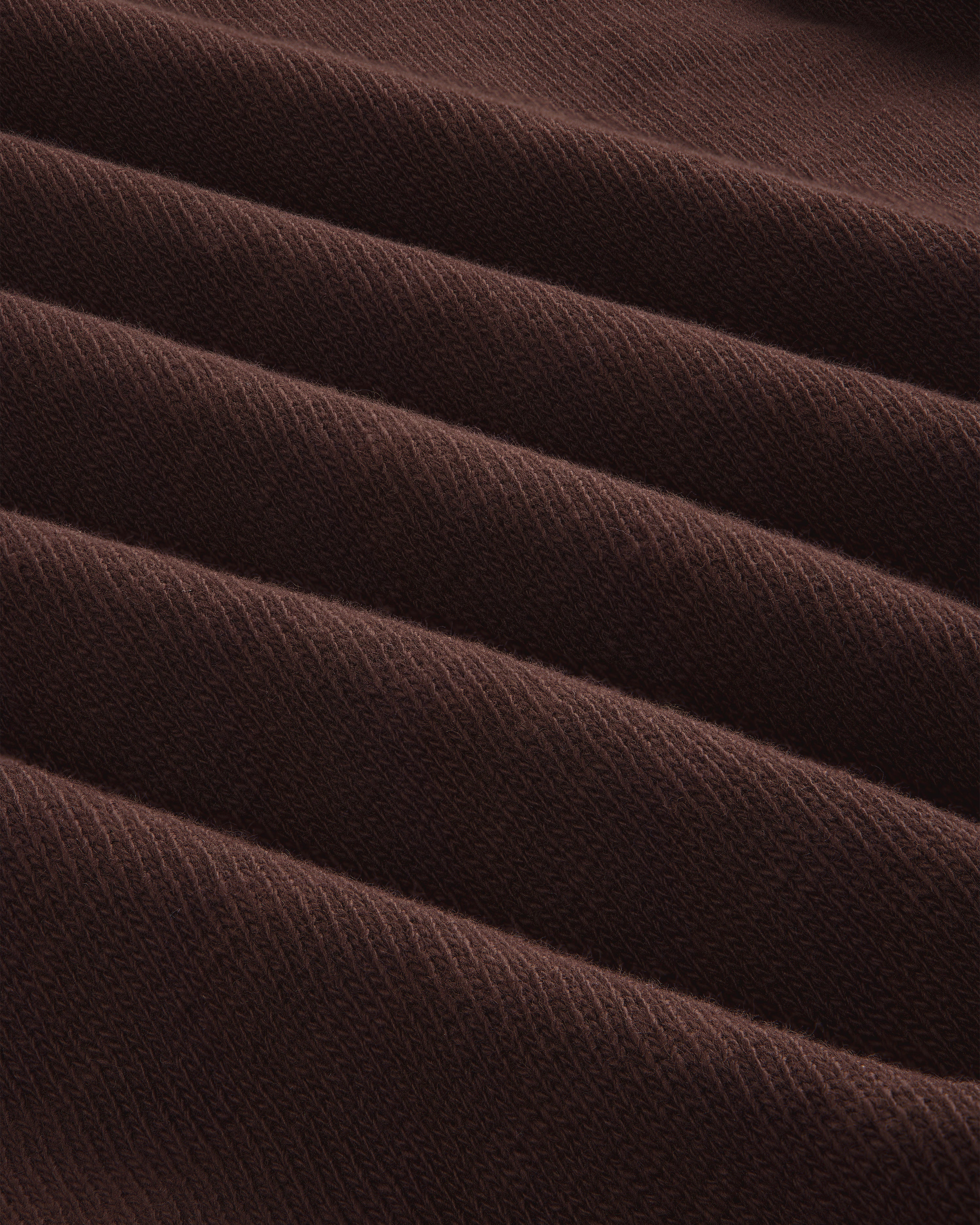 Close-up of Long-Sleeve Slub Football Tee in dark brown, showing ribbed fabric with diagonal texture and repeating ridges.