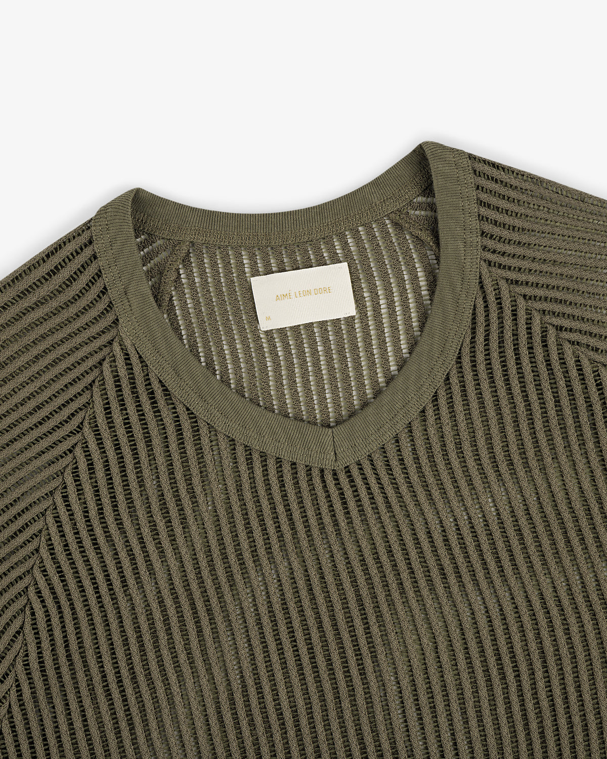 Olive green mesh V-neck tee featuring a visible woven label inside the collar.